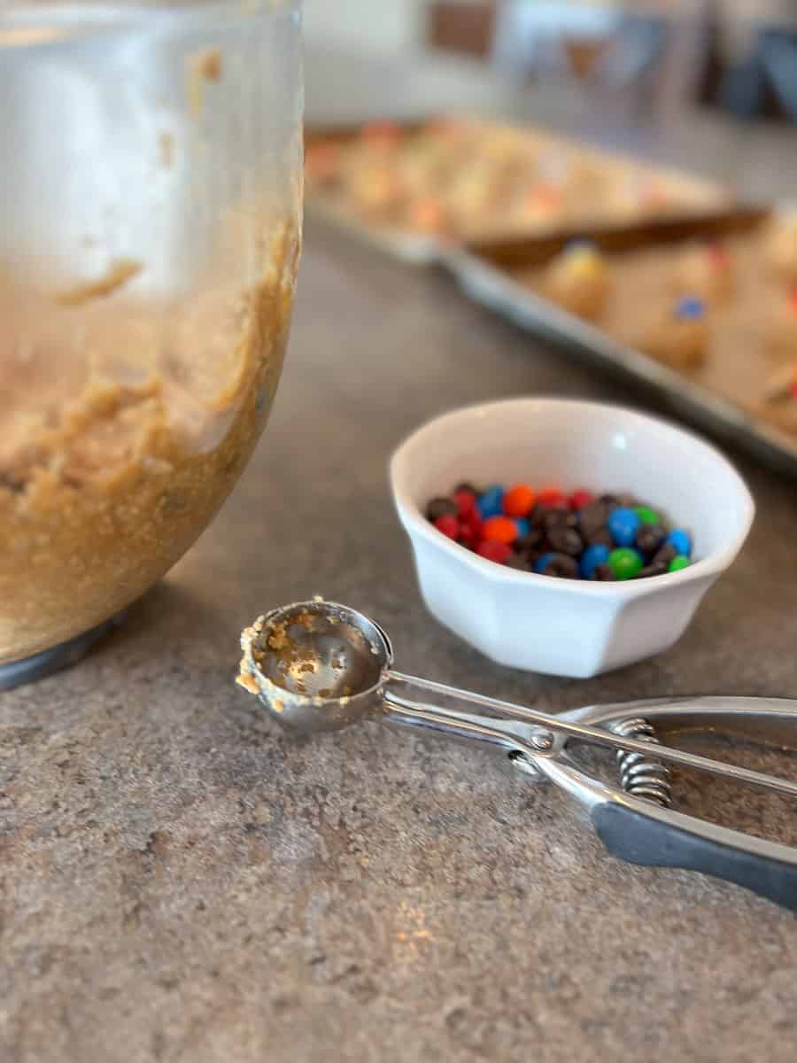 Mixing Bowl, Cookie Scoop and small bowl filled with m&ms