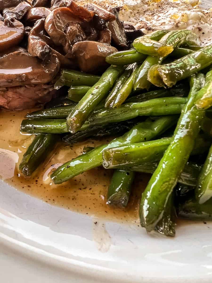 glazed sweet and salty green beans with a steak and baked potato