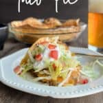 taco pie on white plate with beer.