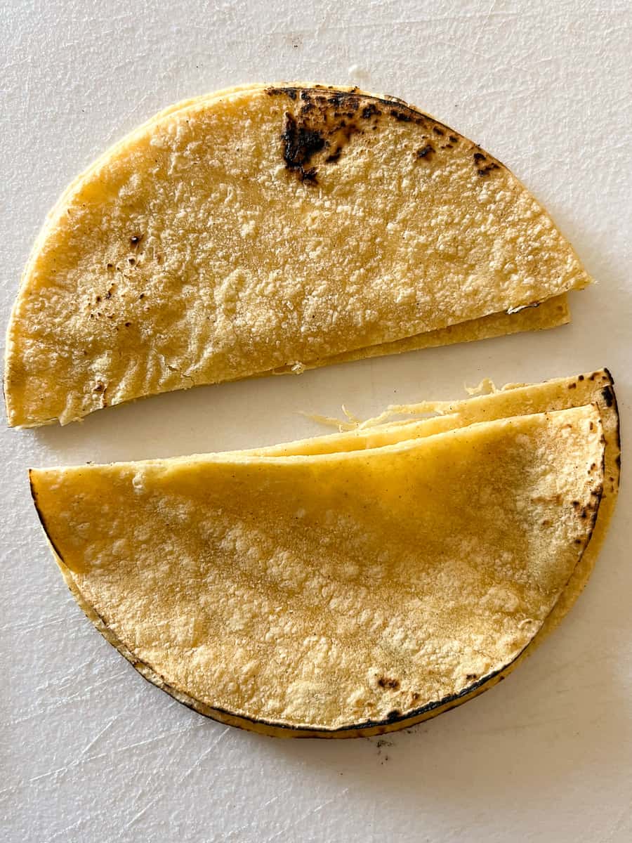 Corn tortillas cut in half.