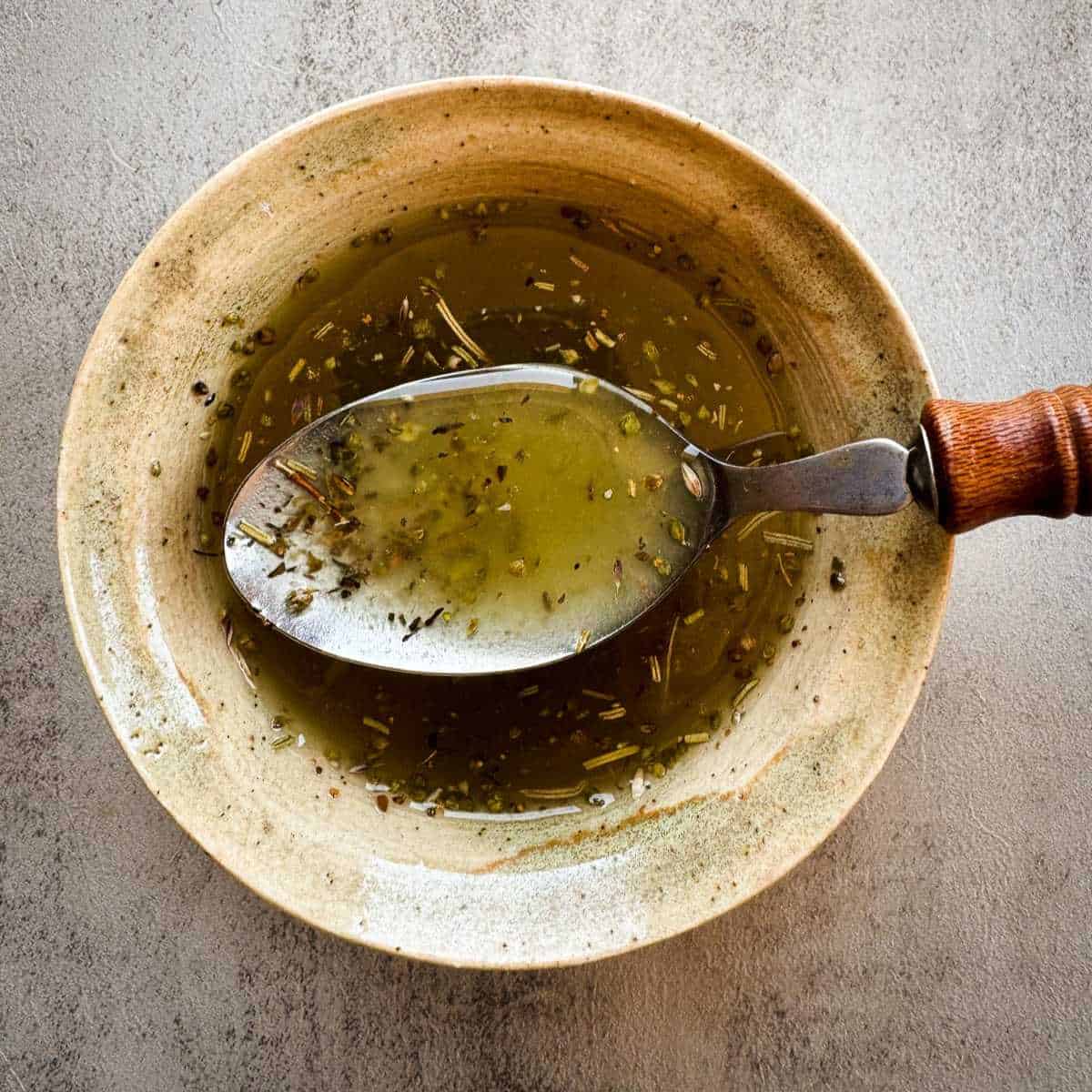 small bowl with dressing and a spoon in the center.