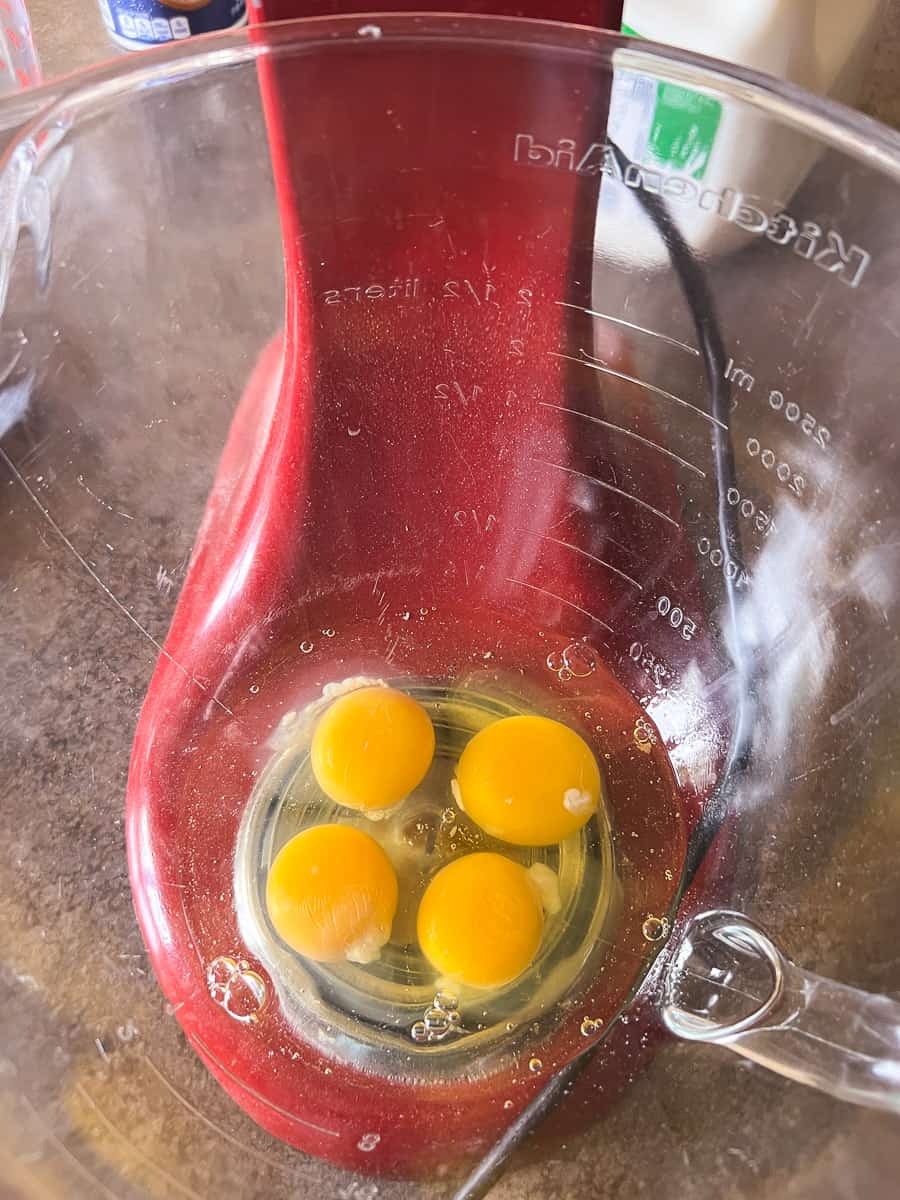 four eggs in mixer bowl.