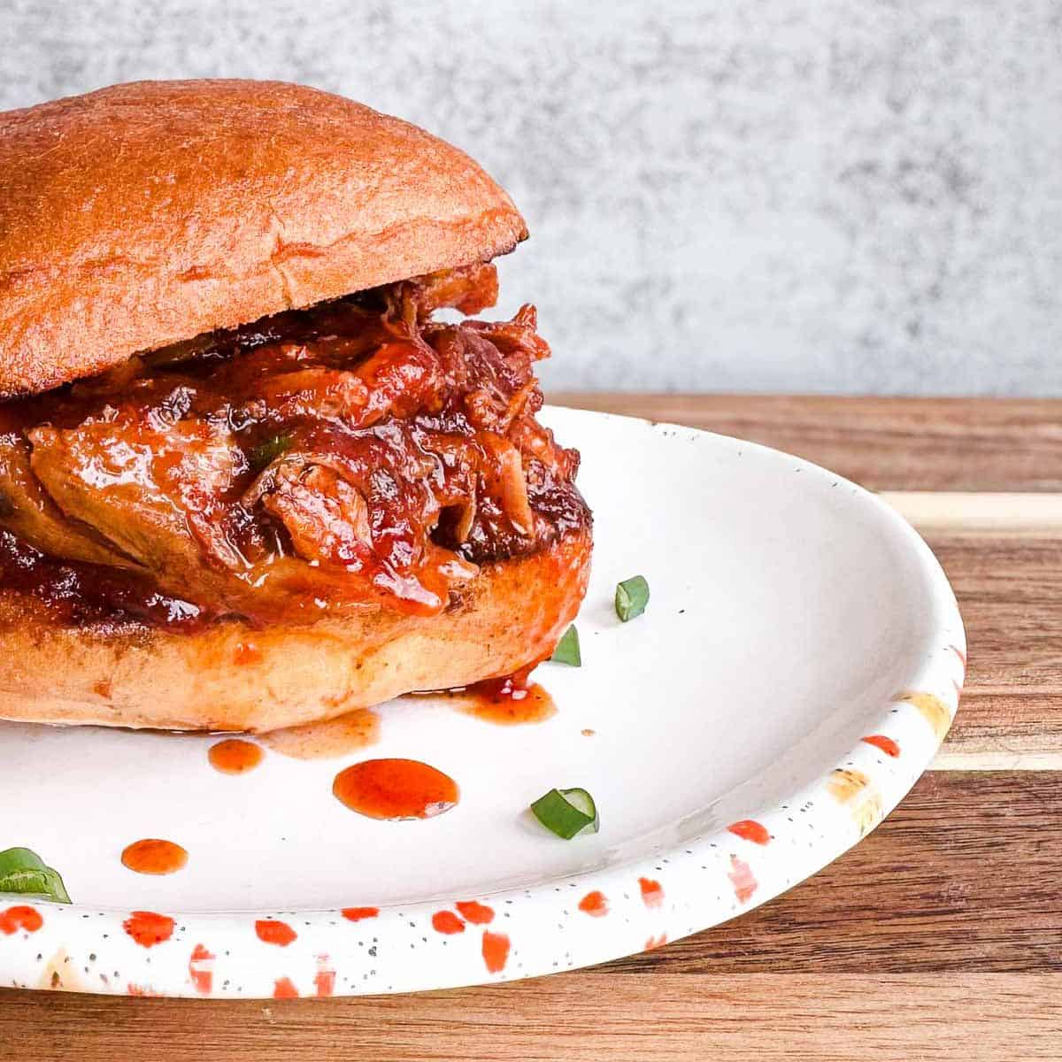 bbq pulled pork on a toasted hamburger bun.