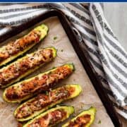 zucchini halves on a baking sheet.