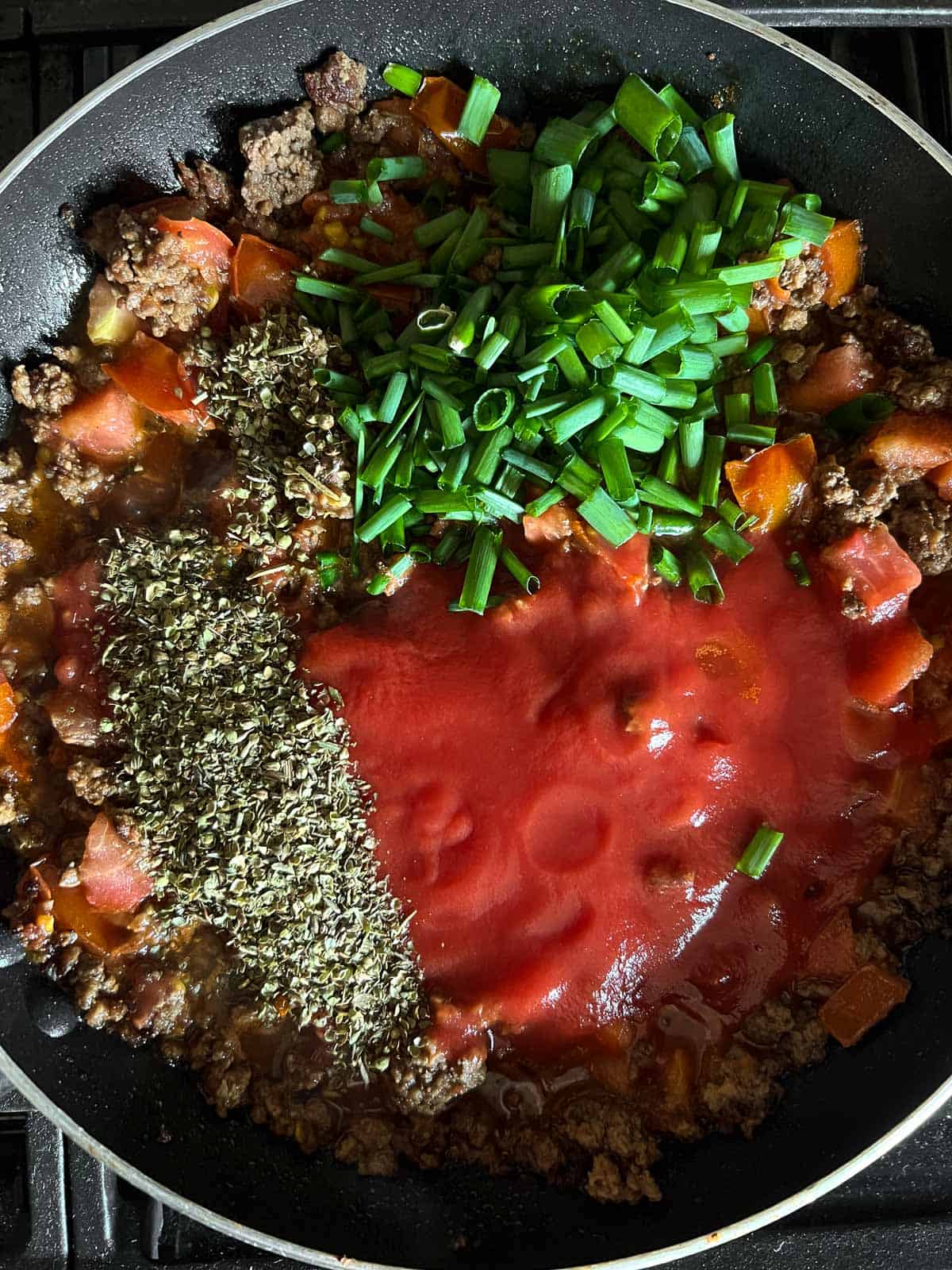the skillet add tomato sauce, green onions, seasonings. 