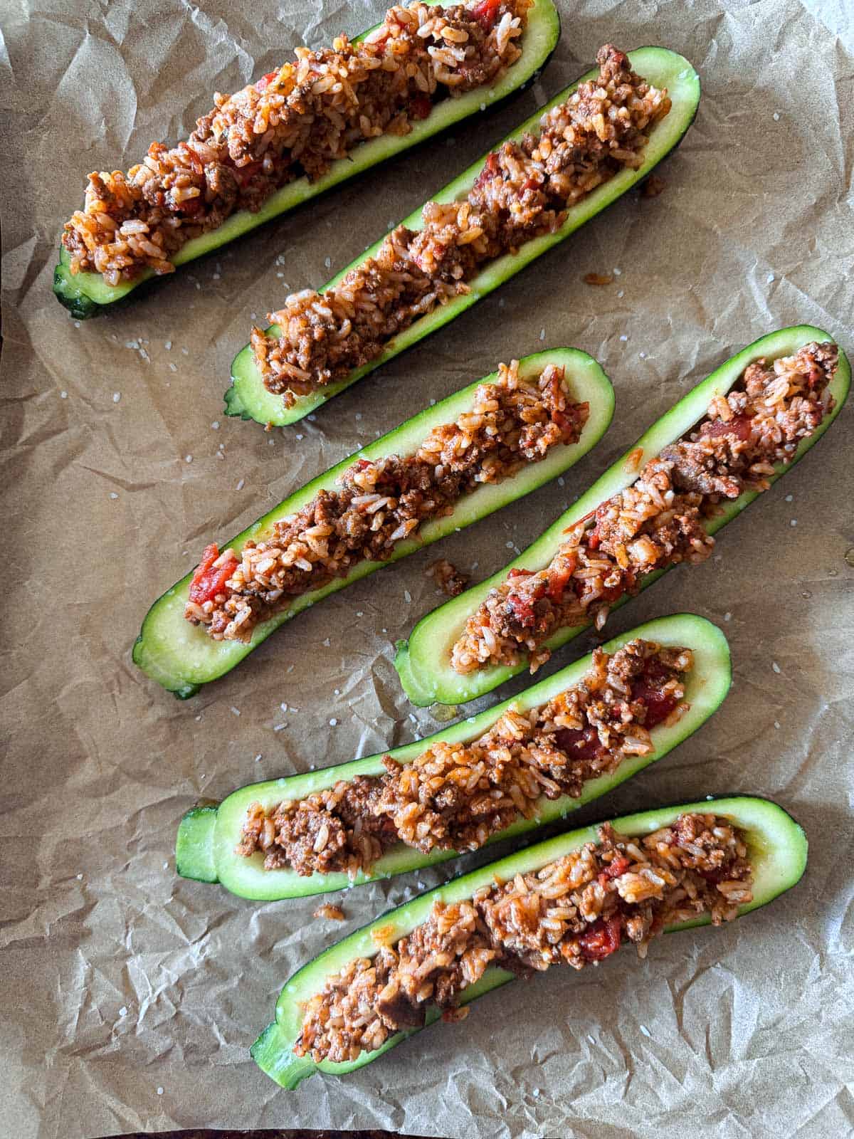 baking sheet with stuffed zucchini halves with the ground beef and rice mixture. 