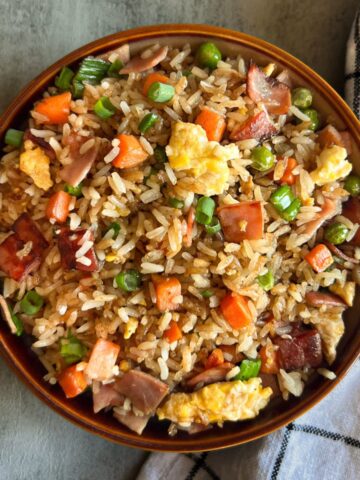 bowl of fried rice with a white and black napkin.