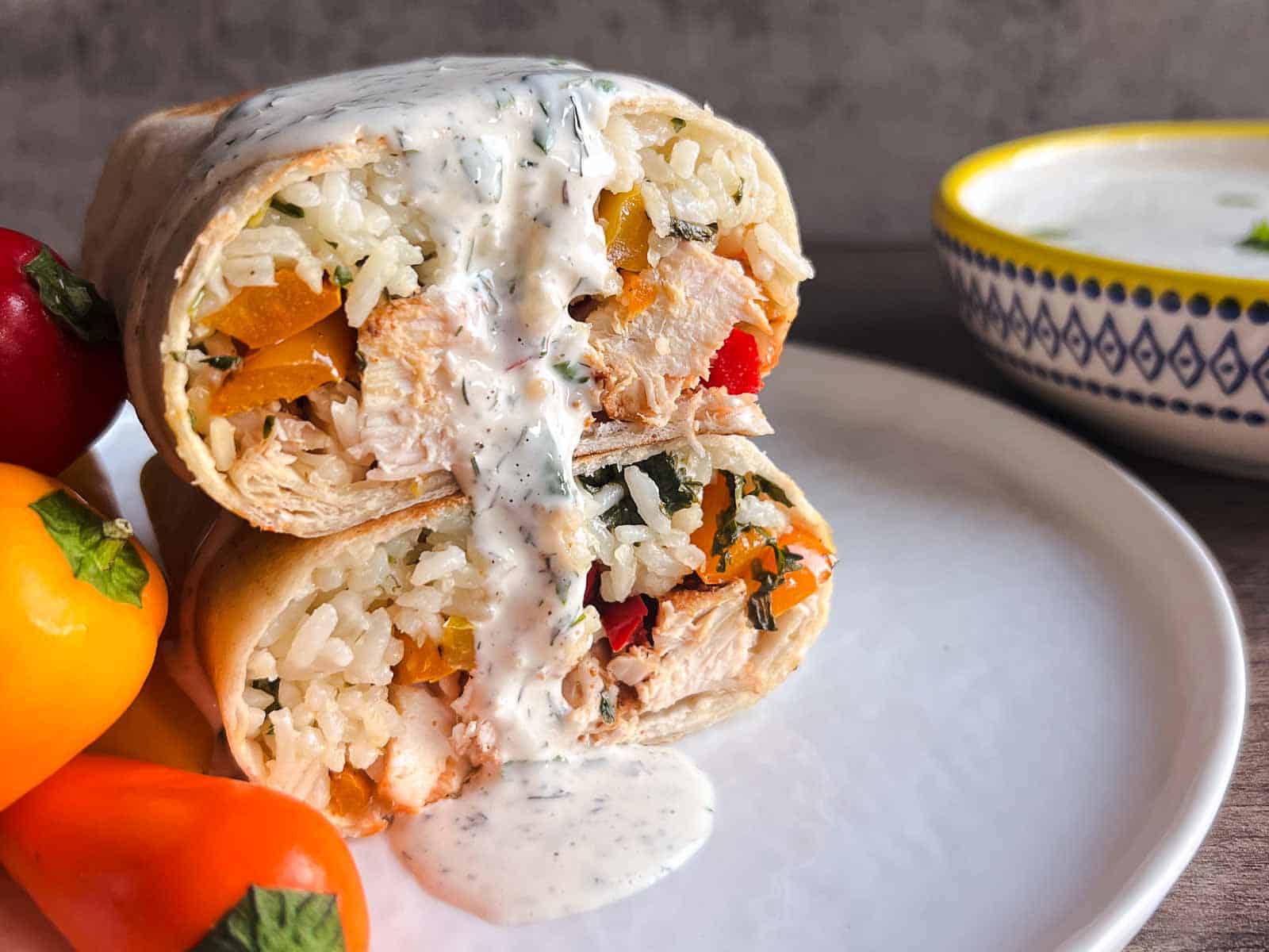 halved chicken burrito with ranch dressing dripping down.