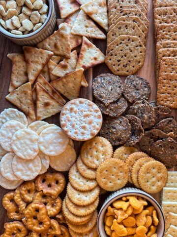 wooden board filled with a variety of crackers.