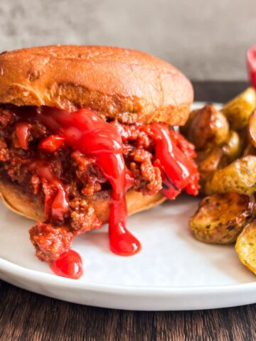 low fodmap sloppy joe's on a white plate with roasted potatoes.