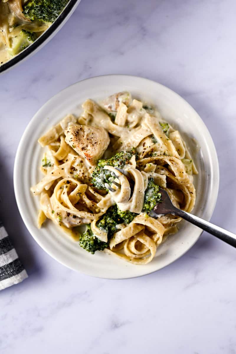 plate of alfredo with a fork.