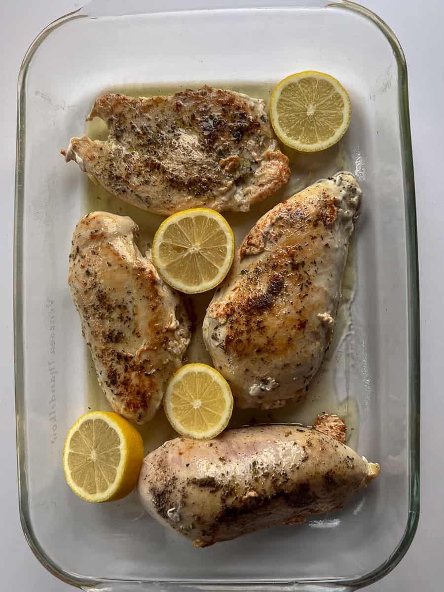chicken and lemon slices in a 9x13 inch baking dish.
