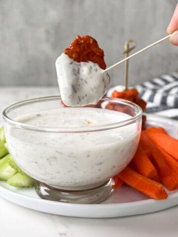 chicken bite dipped in ranch dressing.