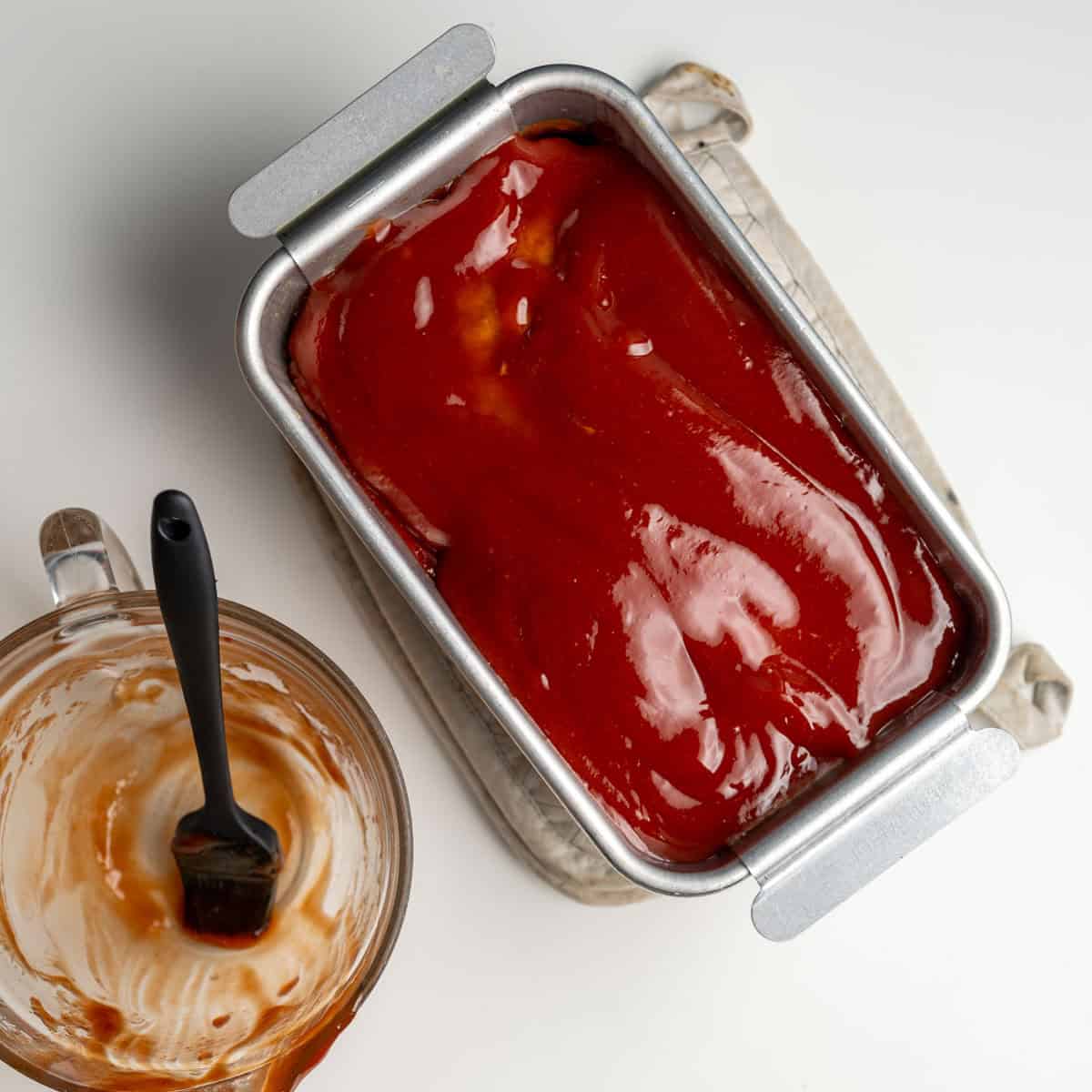 glazed meatloaf in a meatloaf pan.