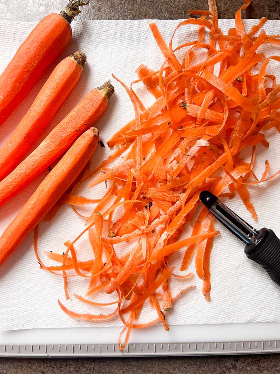 peeled carrots on a cutting board.