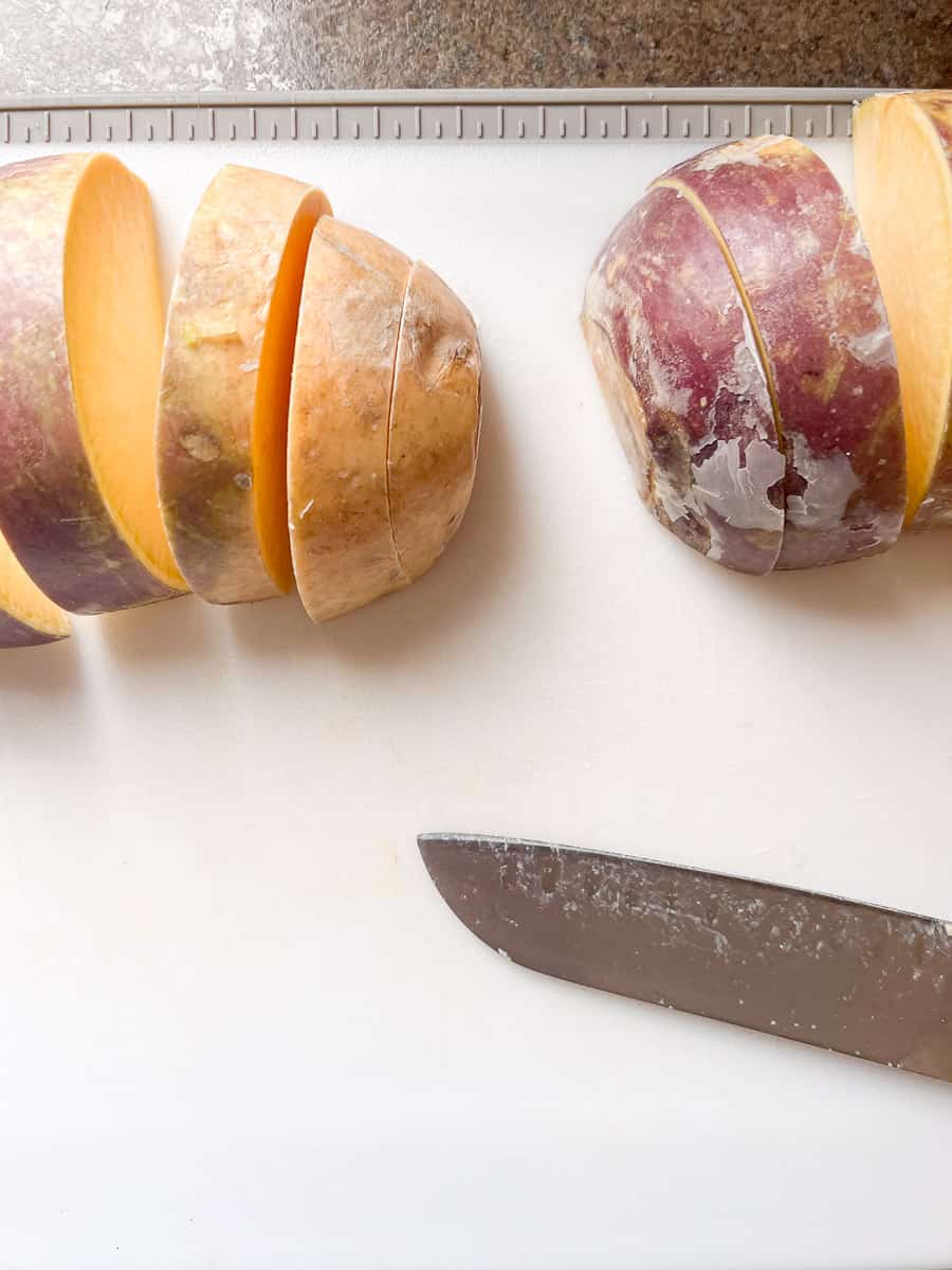 rutabaga on a cutting board with a knife.