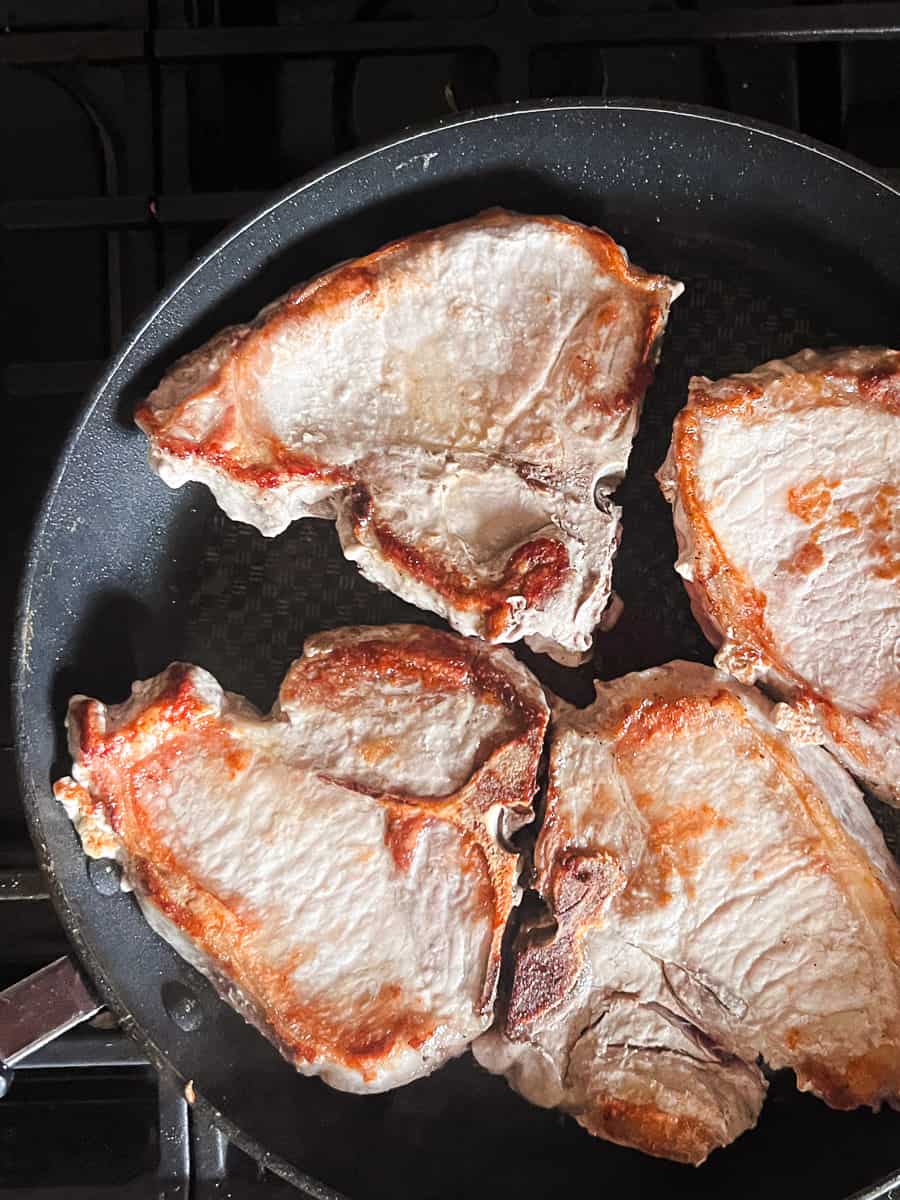 golden brown pork chops in a large skillet.