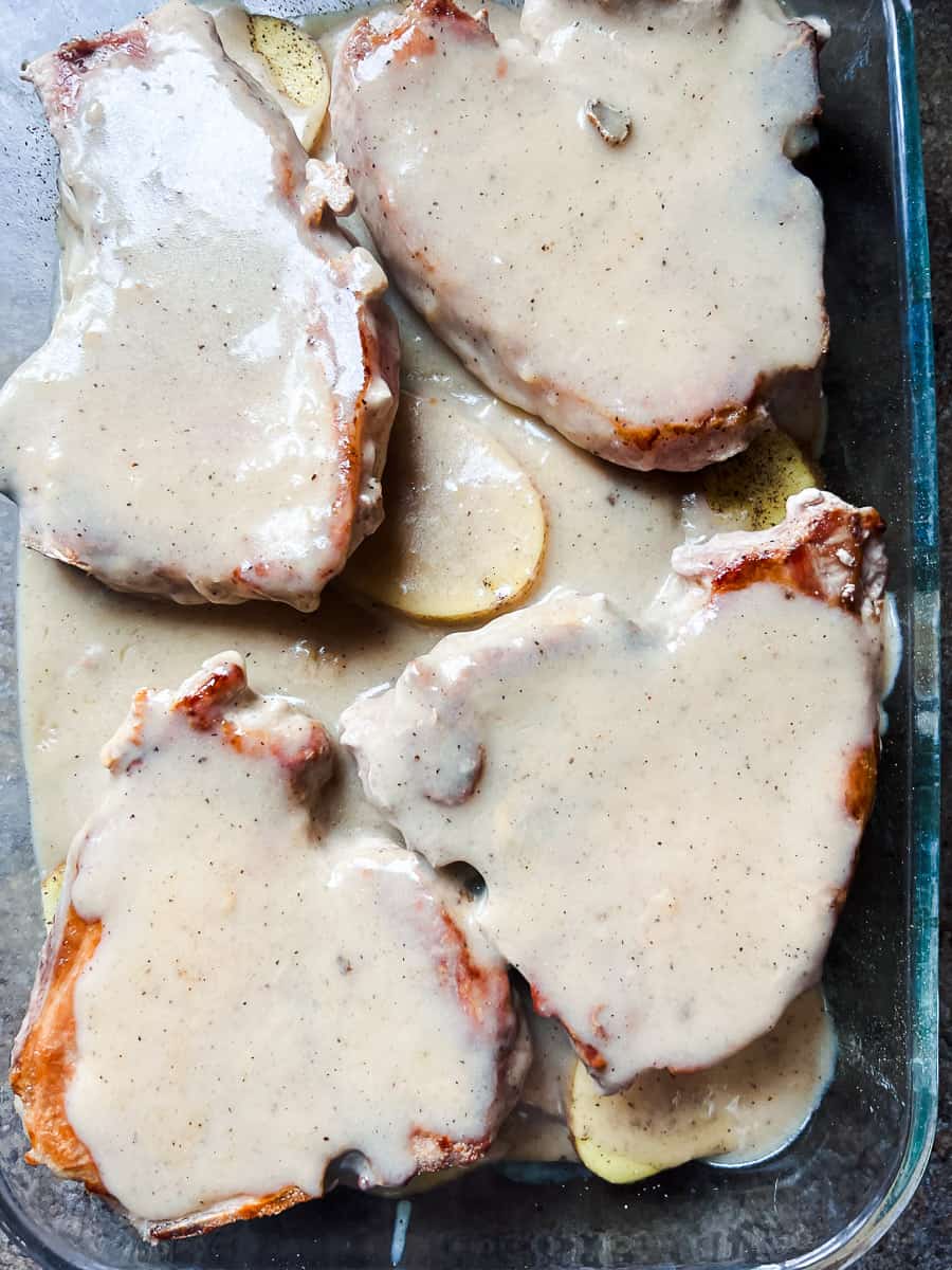 sauce over the pork chops and potatoes in baking dish.