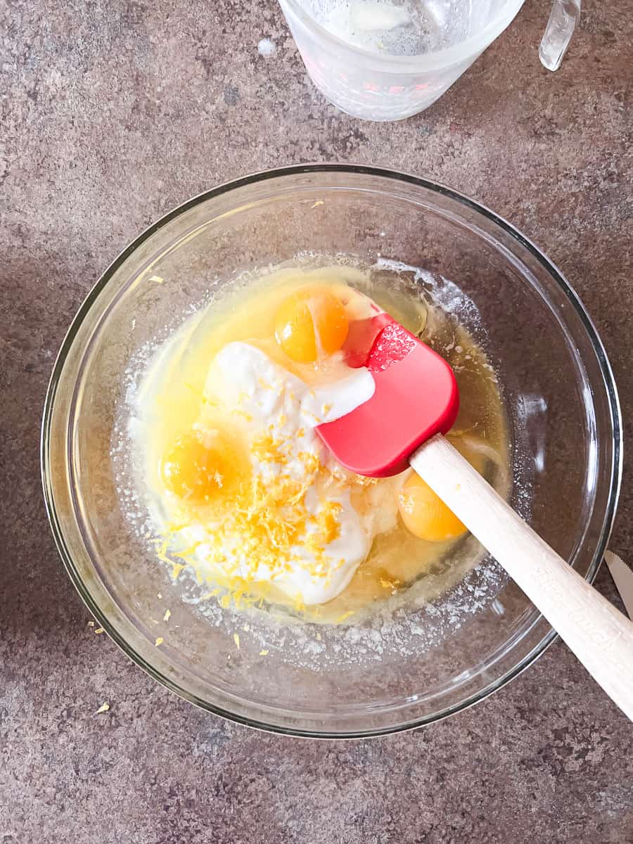 eggs, yogurt, lemon zest, butter, and sugar in glass bowl.