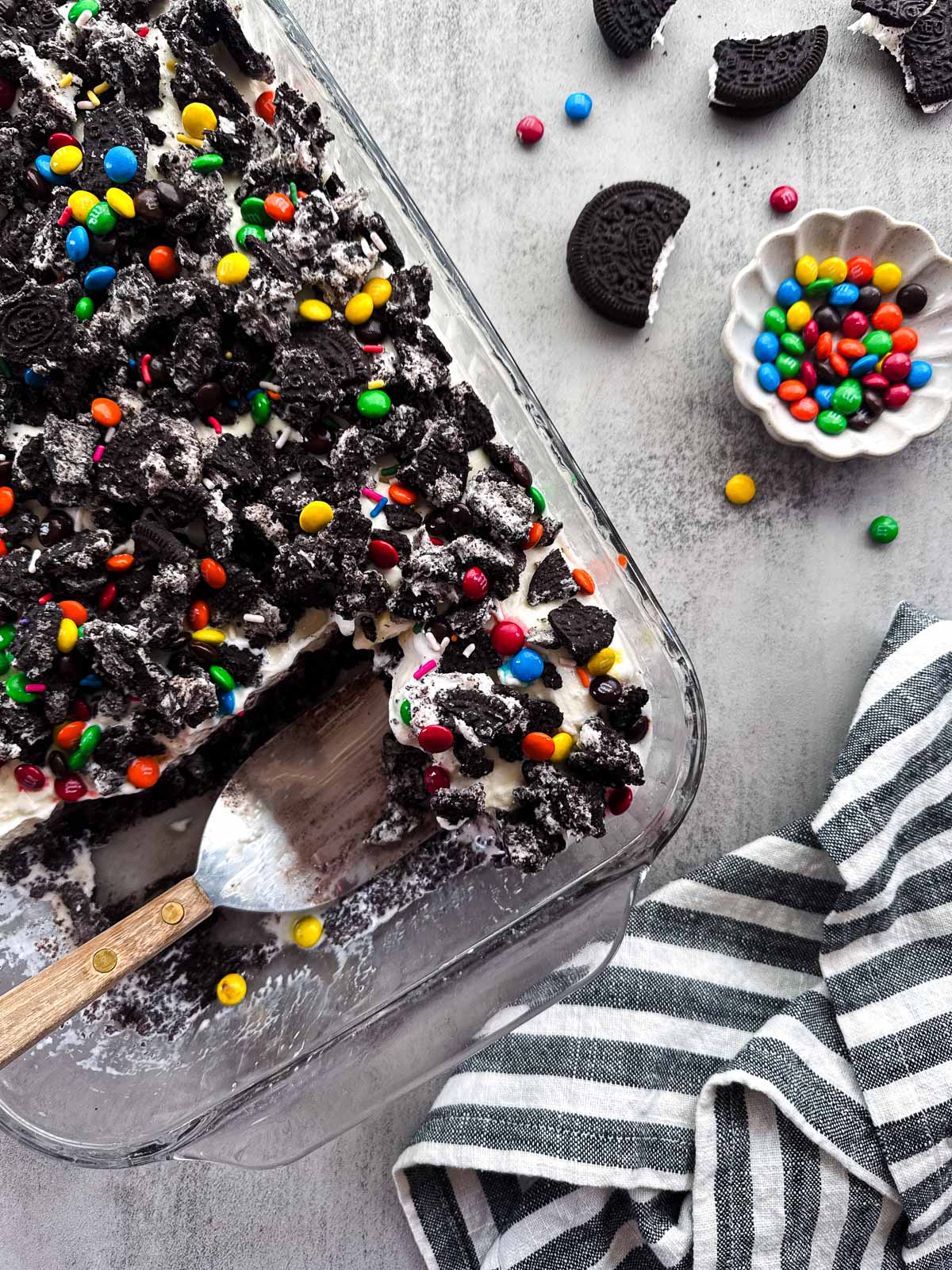 pan of frozen brownie cake with two pieces missing.