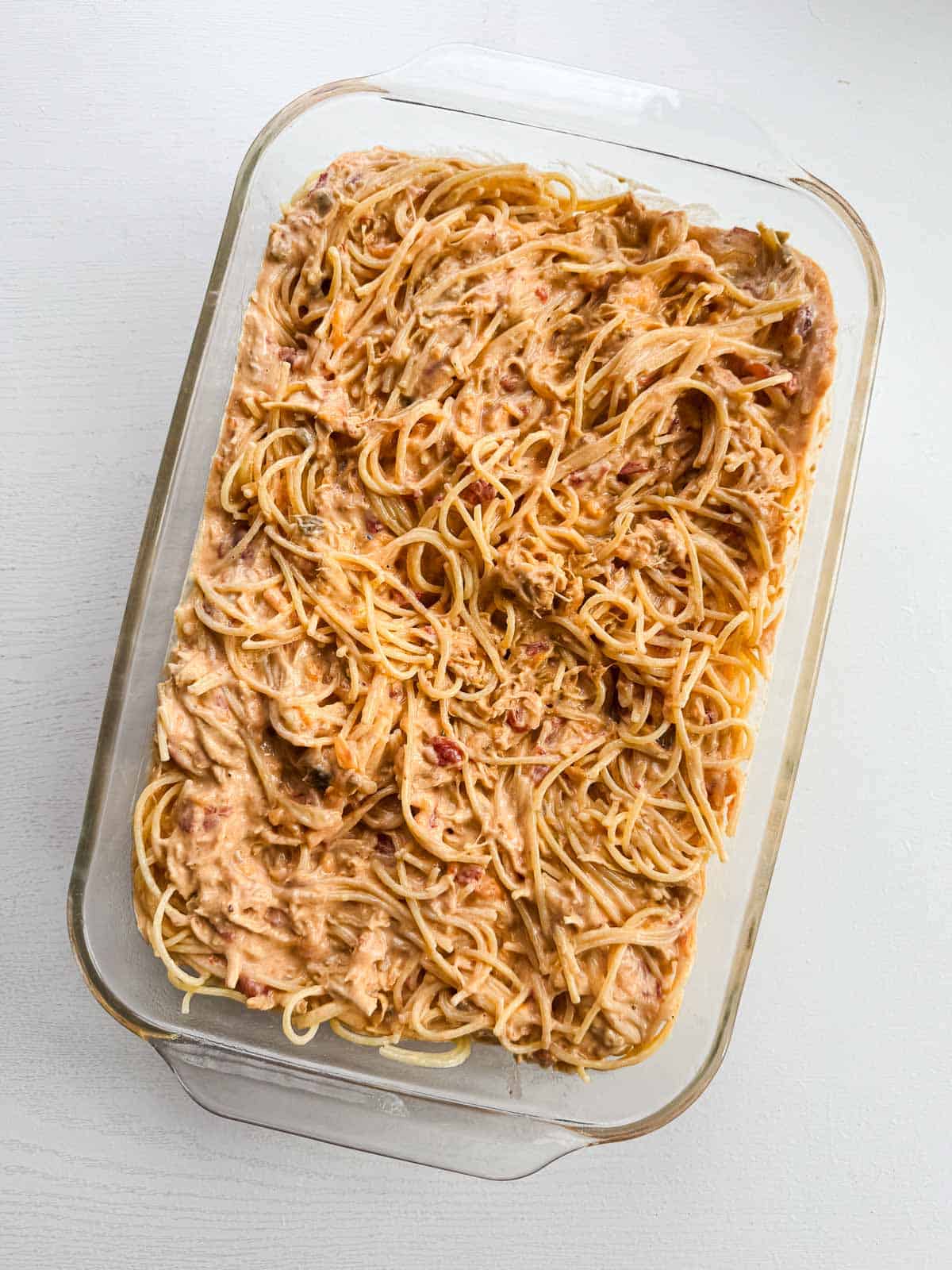 9x13 inch baking dish with chicken spaghetti ready to go in the oven.