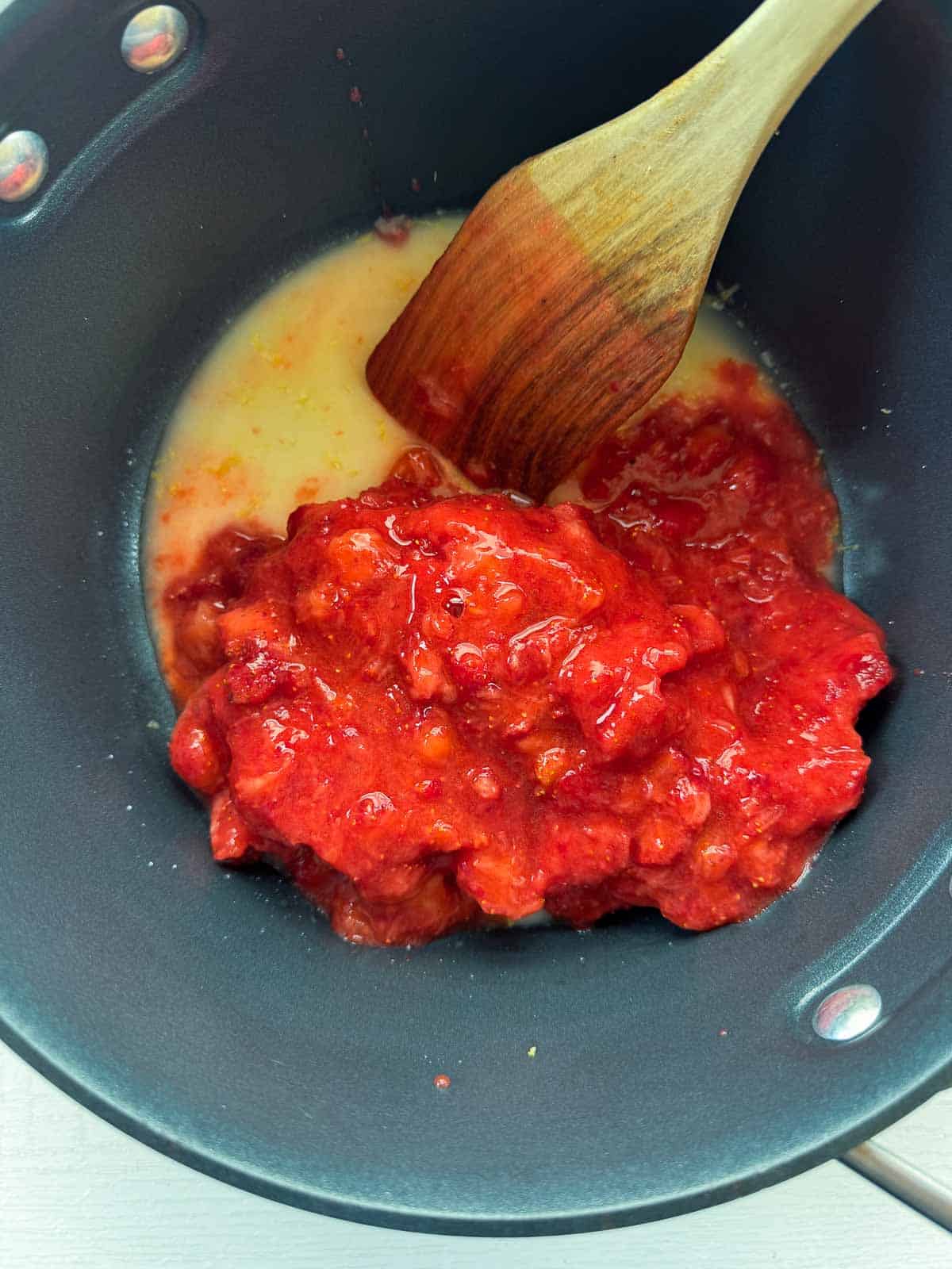saucepan with all the ingredients with a wooden spoon.