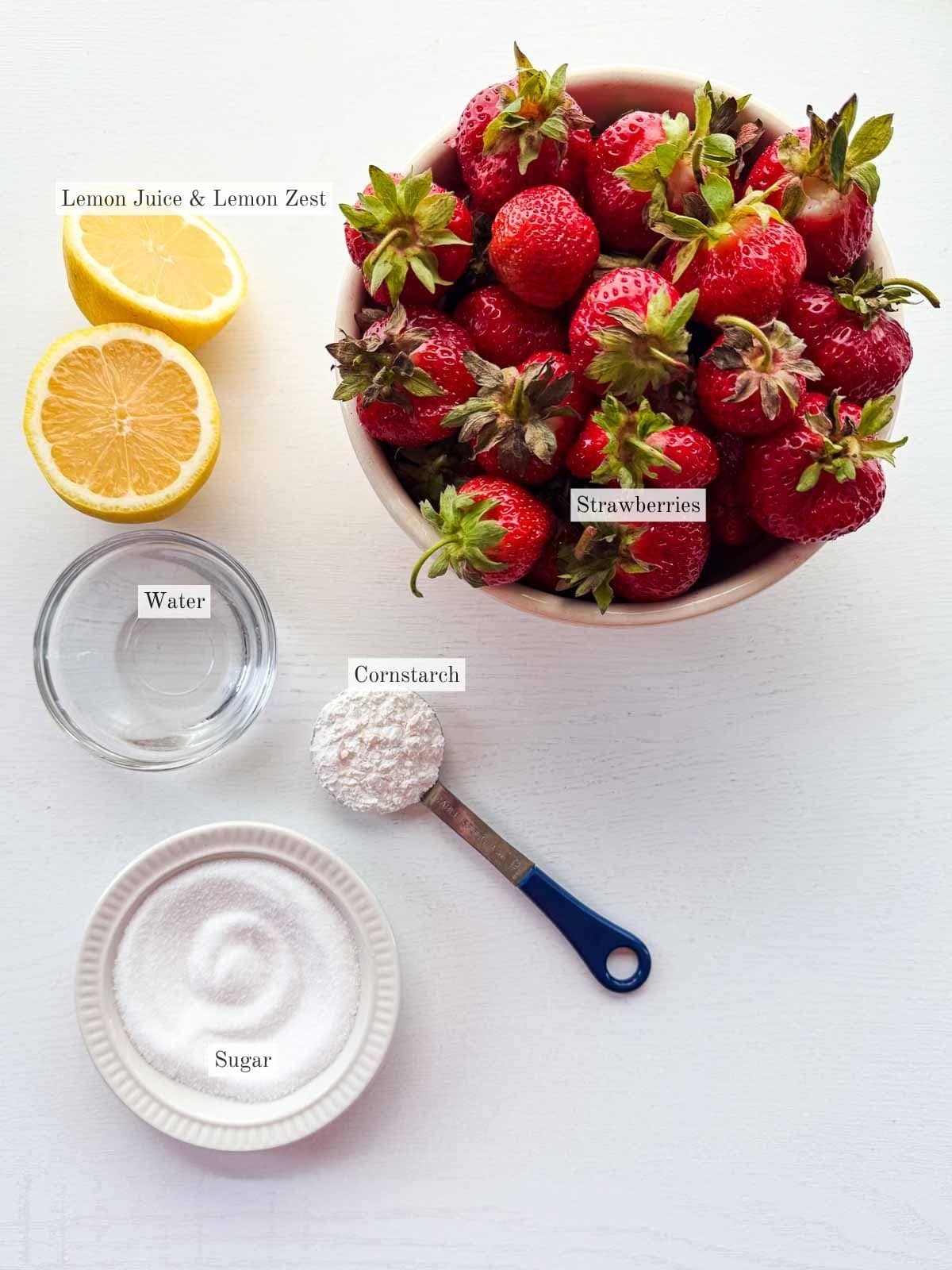 flat lay of all the ingredients for strawberry sauce.