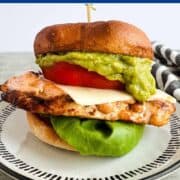 Chicken sandwich with guacamole and lettuce.