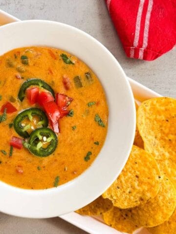 bowl of queso and yellow tortilla chips.
