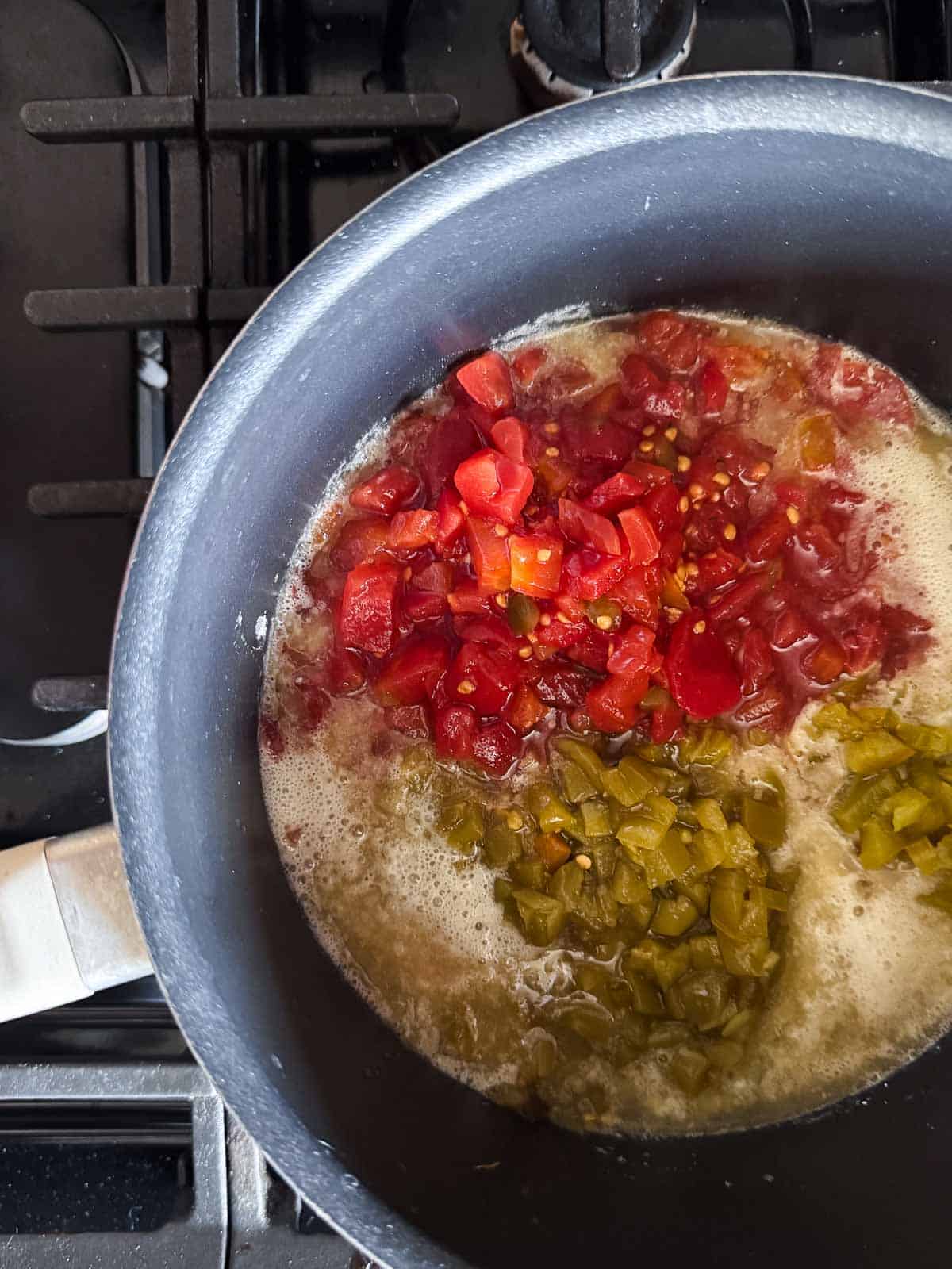 in a medium saucepan is the rotel, green chilies and jalapenos.
