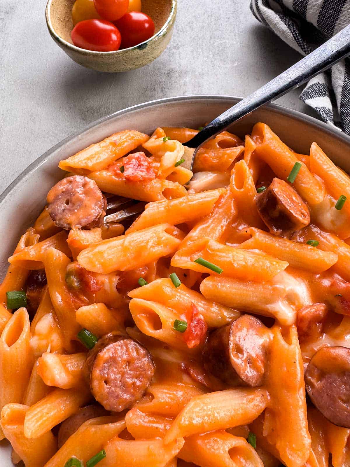 Easy one pot pasta with turkey bratwurst, cheese curds and tomatoes.