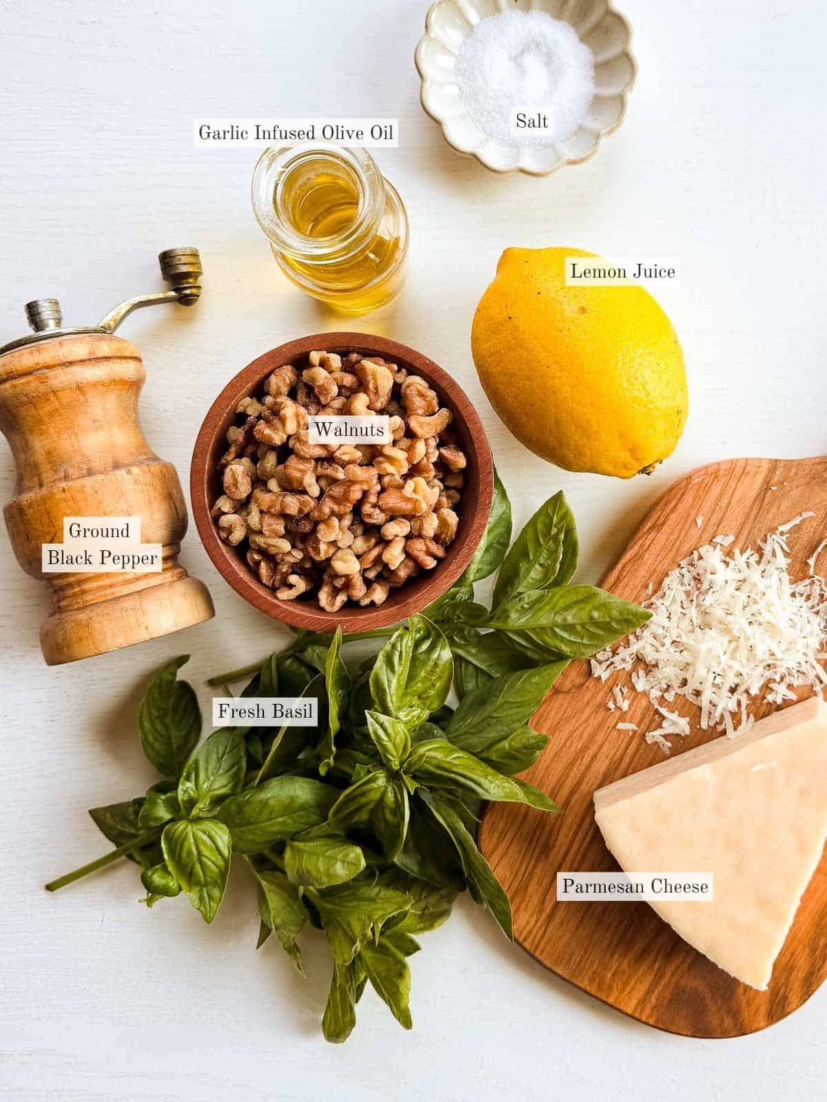 ingredients for pesto on a white table.