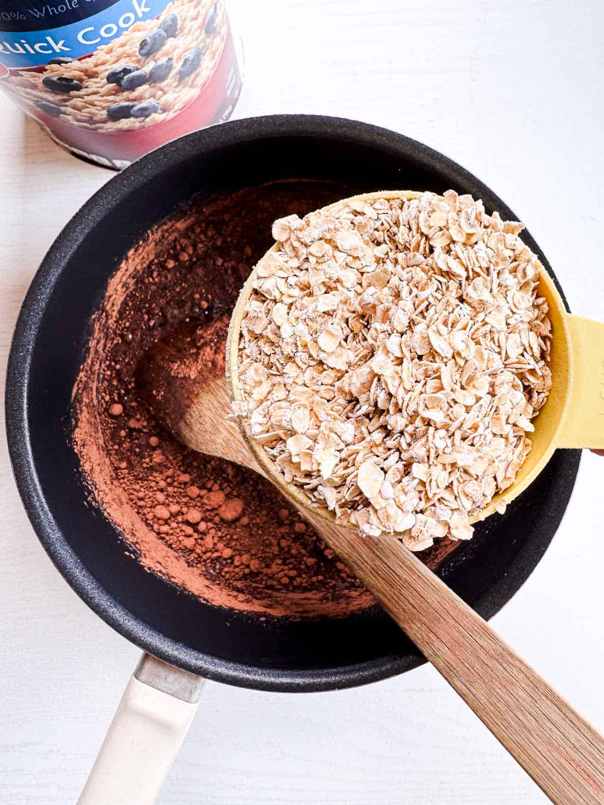 quick cooking oats added to the cocoa powder mixture in a saucepan.