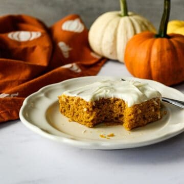 a bit missing from a gluten free pumpkin bar on a plate with a fork.