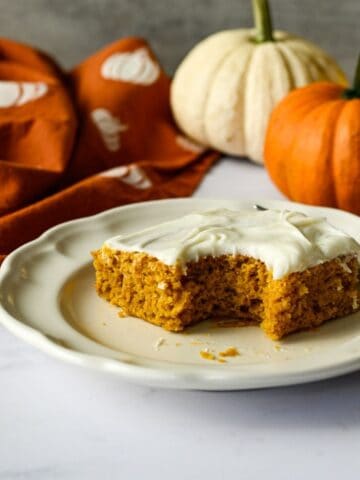 a bit missing from a gluten free pumpkin bar on a plate with a fork.