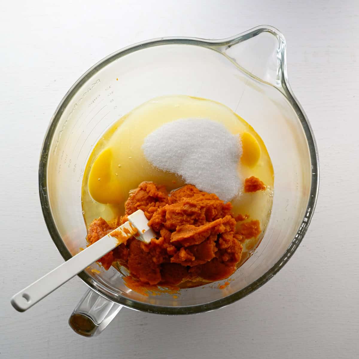 wet ingredients in a mixer bowl with a scraper.