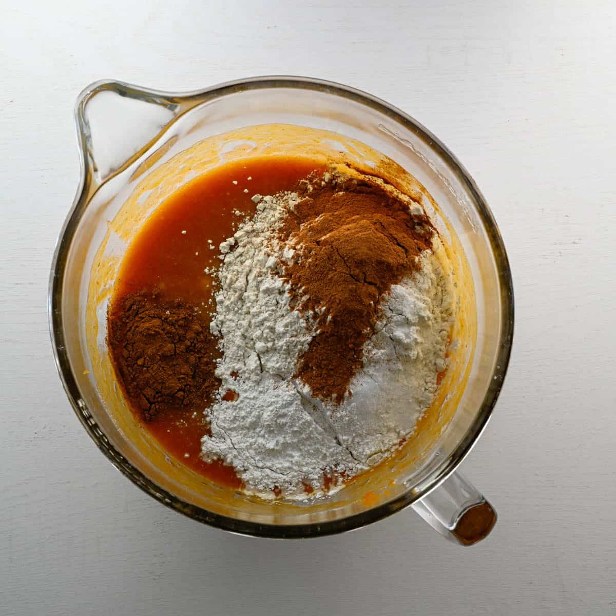 dry ingredients added to the wet ingredients in a mixer bowl.