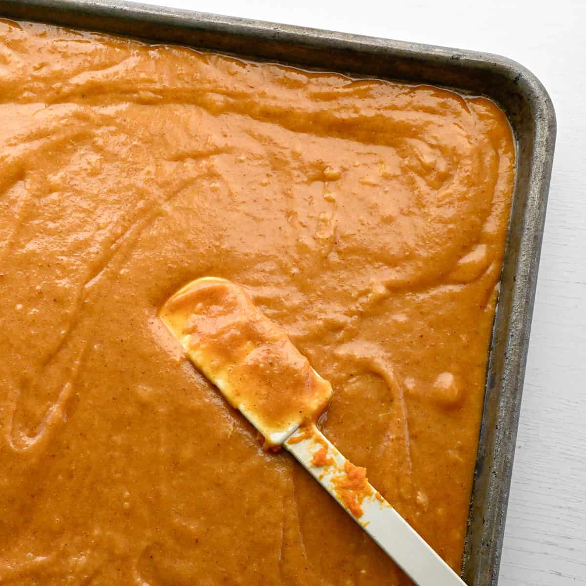unbaked pumpkin bars in a jelly roll pan.