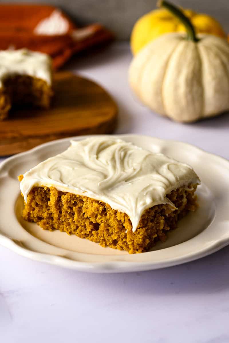 pumpkin bar on a plate with pumpkins and a napkin.