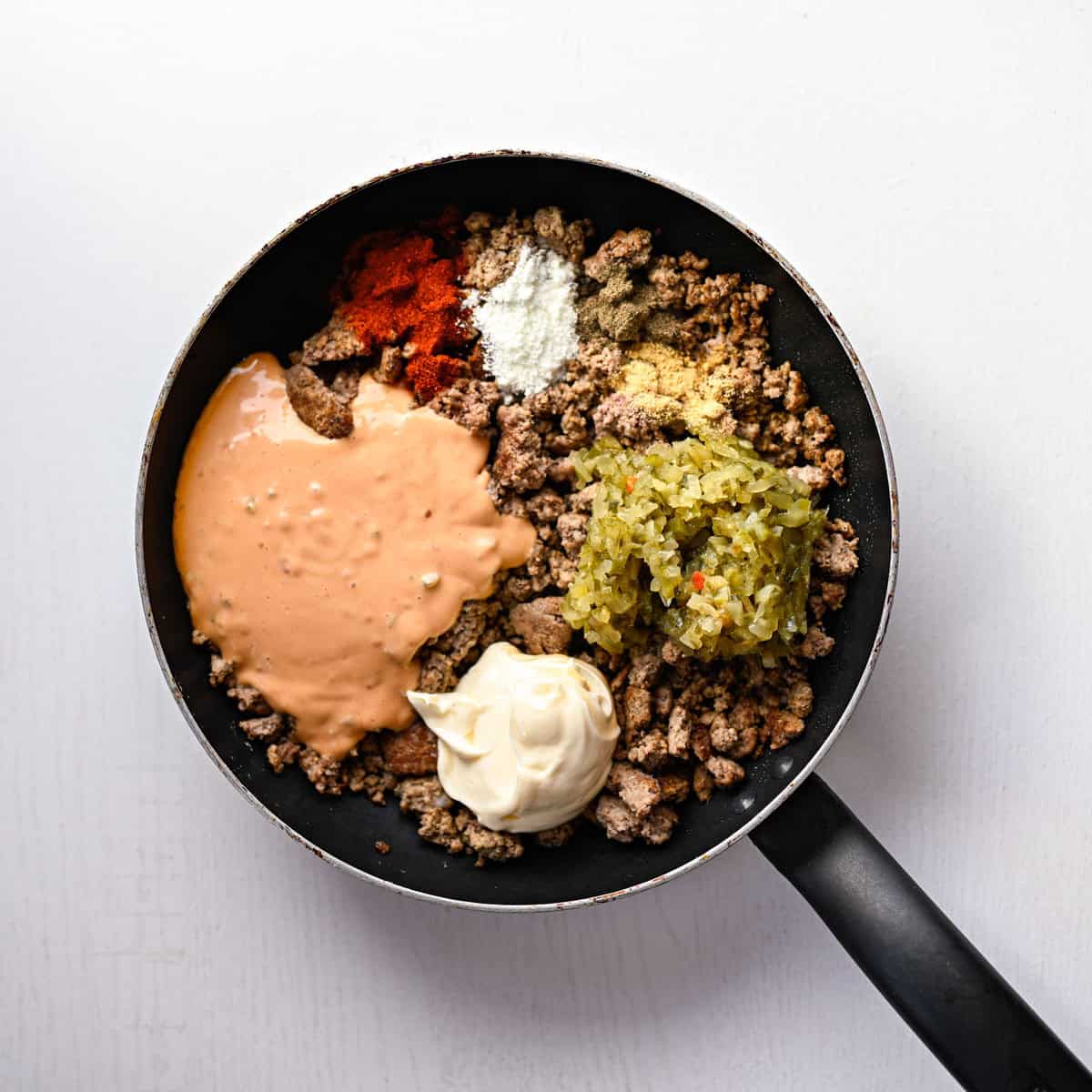 skillet with hamburger, thousand island dressing, dill relish, mayo and spices.