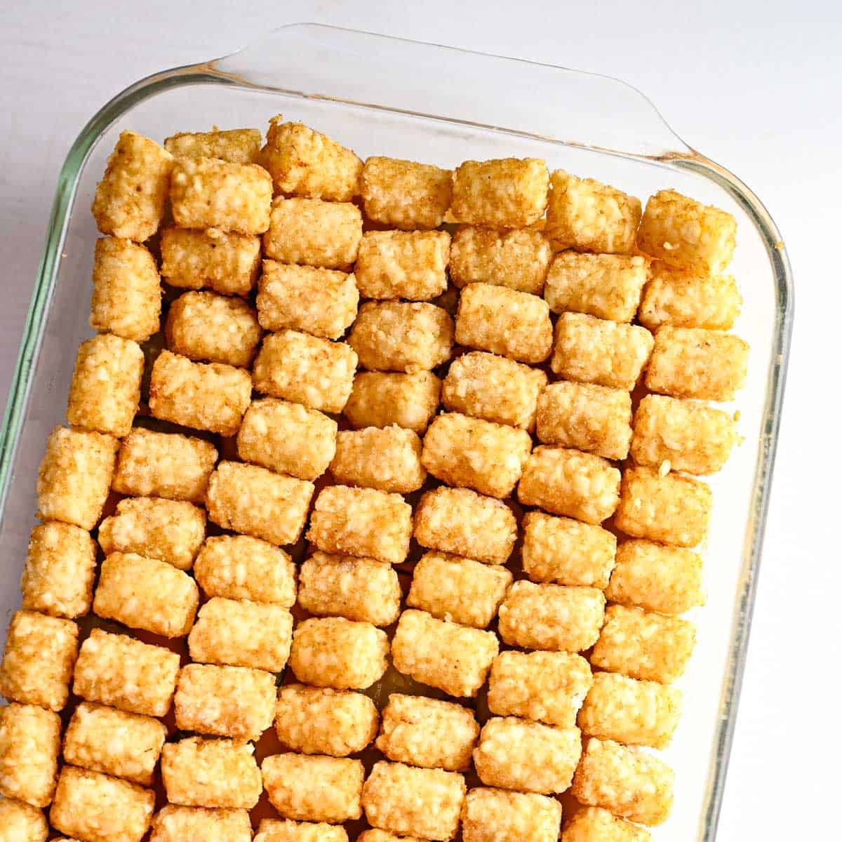 perfectly arranged tater tots as the top layer in the tater tot hotdish.