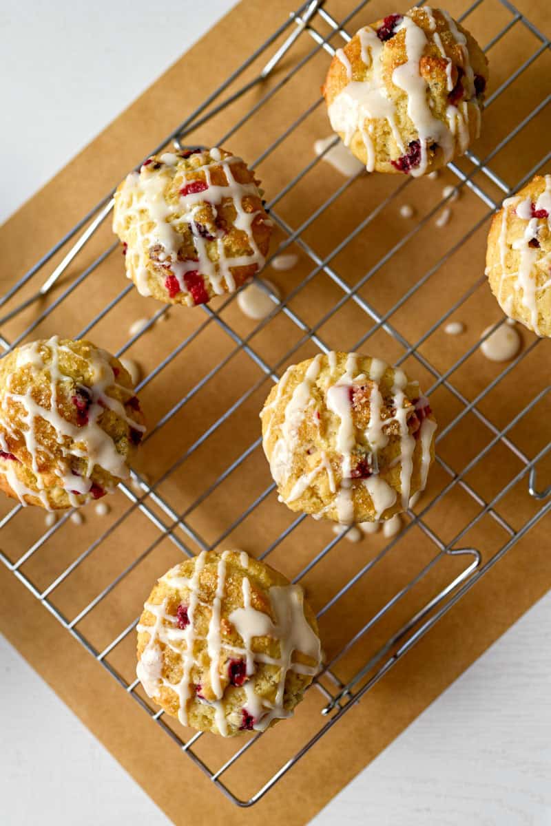 glazed cranberry orange muffins on a cooling rack.