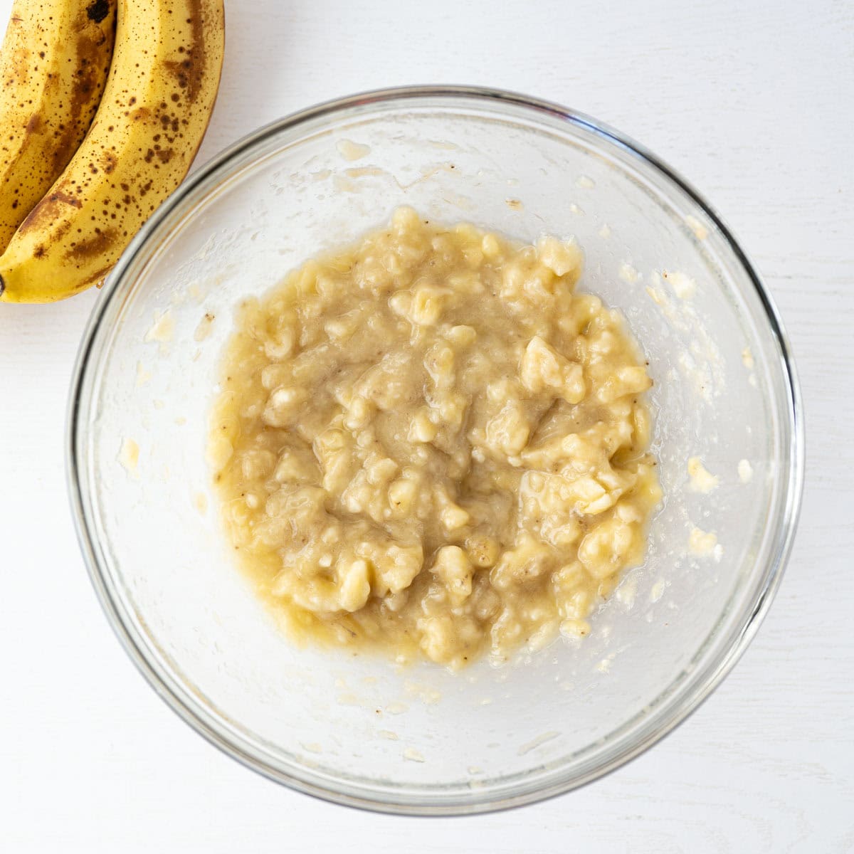 mashed bananas in a mixing bowl.