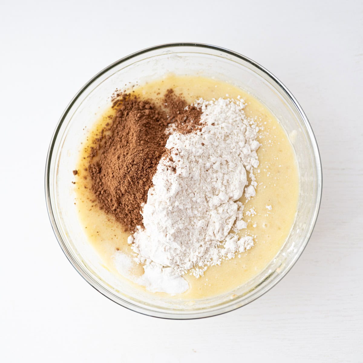 dry ingredients added to the wet ingredients for banana bread.