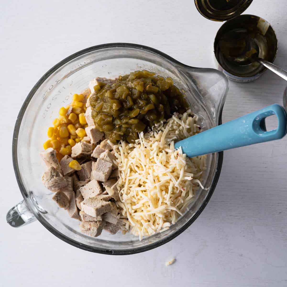 added the veggies, cheese, and chicken into the bowl.
