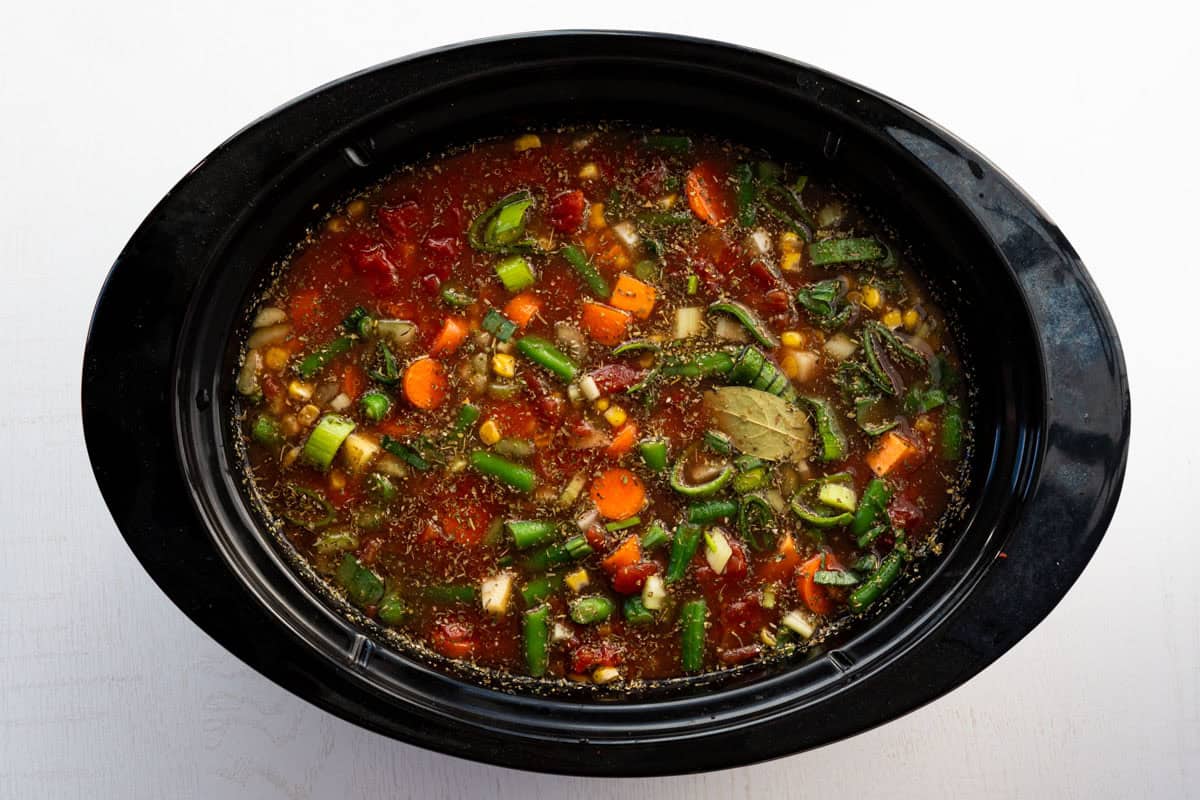 black crock pot liner filled with the soup ingredients.
