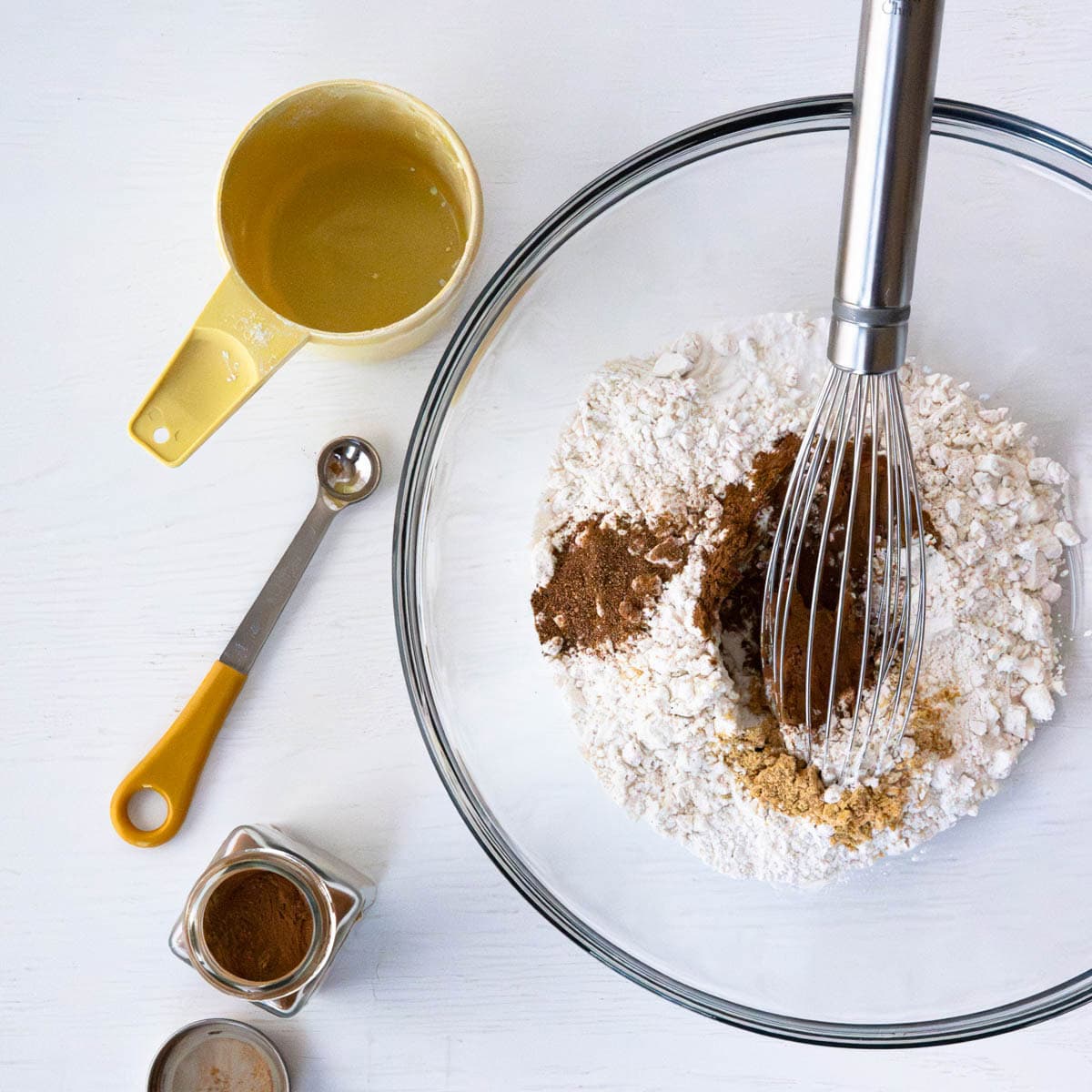dry ingredients in a glass bowl with a whisk.