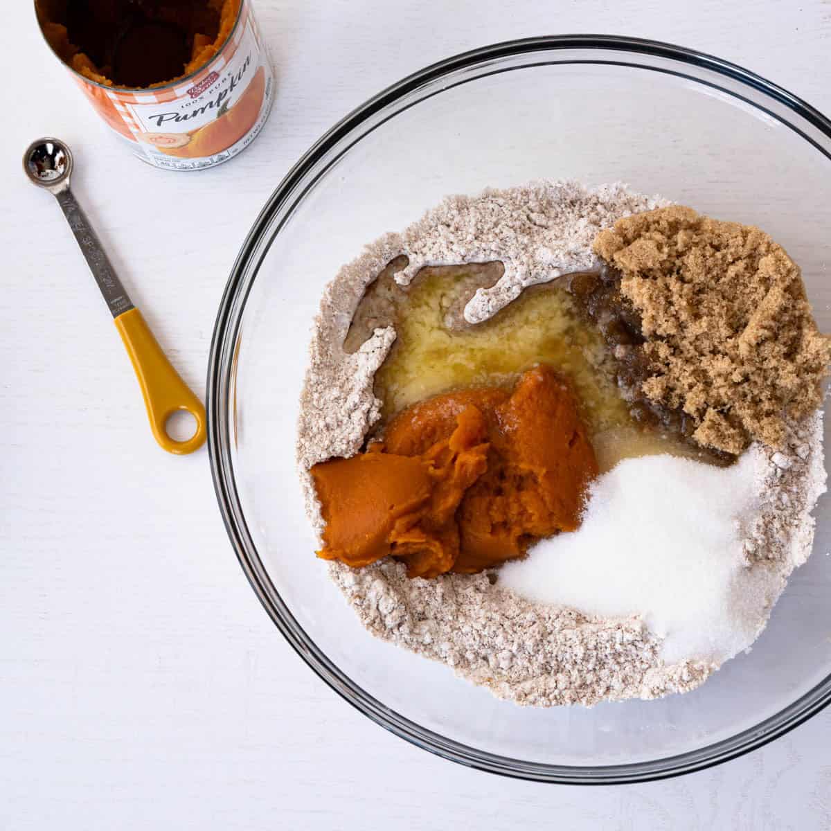 the wet ingredients added to the dry ingredients in a glass bowl.