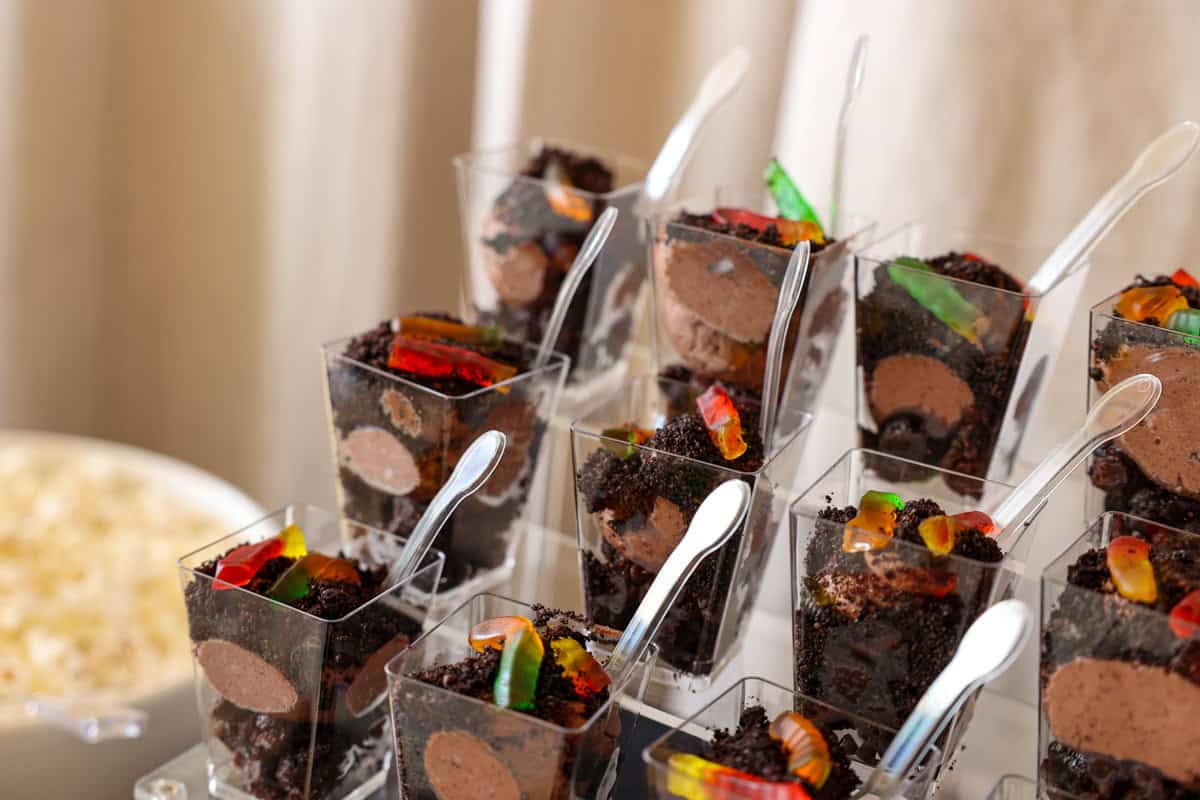 stacked brownie dirt cake cups at a graduation party.