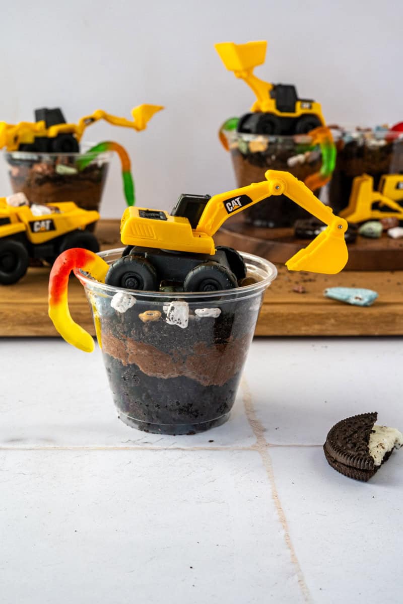 dirt cake cups topped with construction toys.